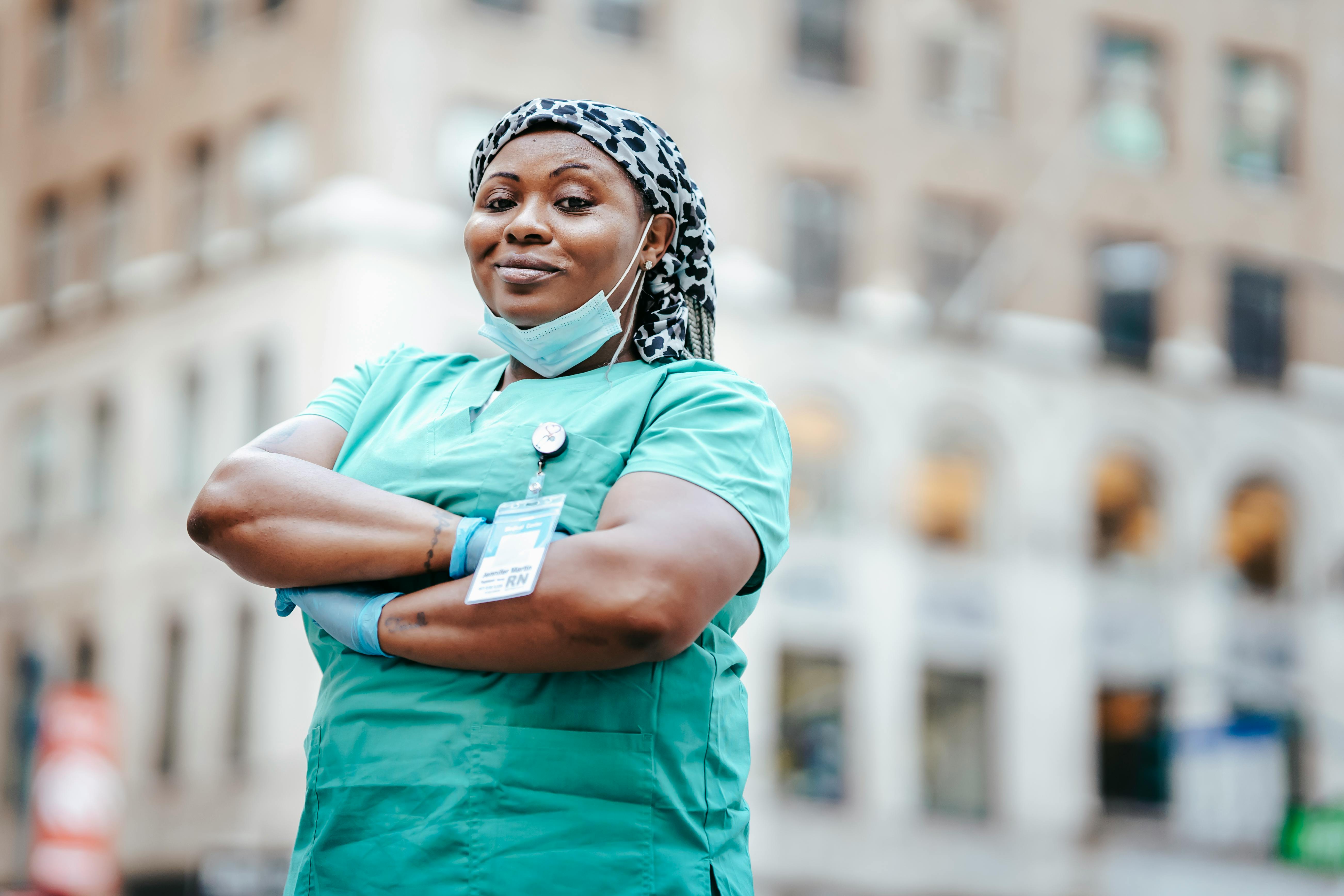 Confident nurse standing outside a hospital